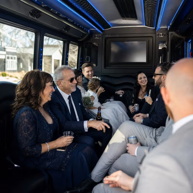 Wedding guests seated inside a Aurora party bus